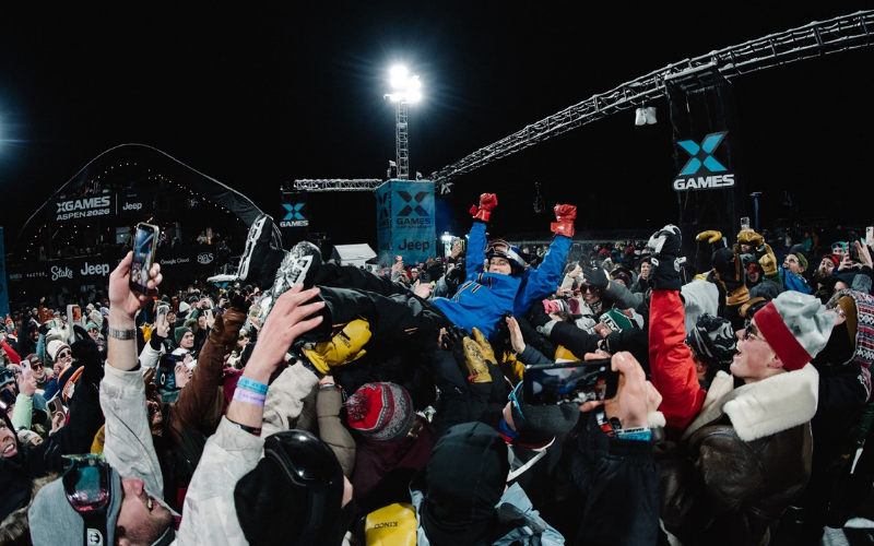 The X Games Aspen crowd celebrating and lifting an athlete